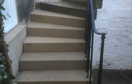 image00025 Repaired exterior stone steps with a black handrail