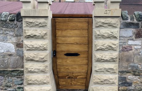 pillars Restored sandstone doorway with a timber entrance door